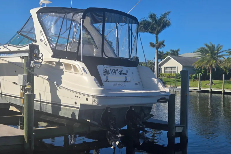 Slide: The Image of 2010 Sea Ray 330 Sundancer docked by a waterfront home with palm trees. - 10