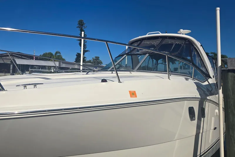 Slide: The Image of 2010 Sea Ray 330 Sundancer boat docked under clear blue sky. - 11