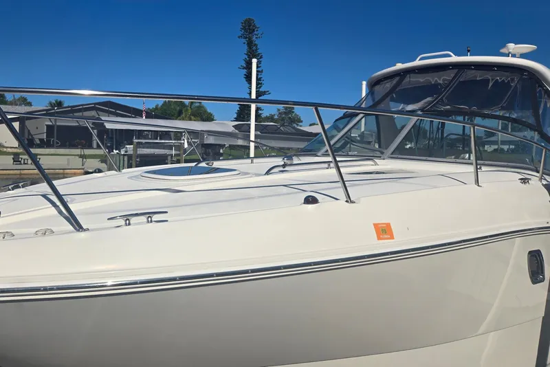 Slide: The Image of 2010 Sea Ray 330 Sundancer boat docked under clear blue sky. - 12
