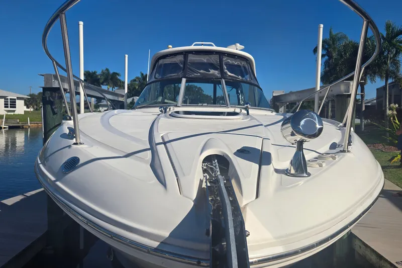 Slide: The Image of 2010 Sea Ray 330 Sundancer yacht docked, showcasing sleek design and modern features. - 13