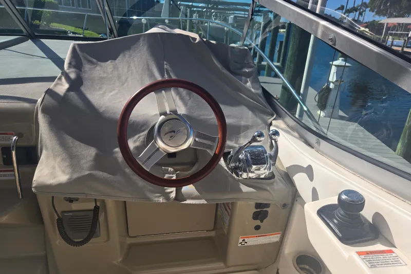 Slide: The Image of Steering wheel and controls of a 2010 Sea Ray 330 Sundancer boat. - 17