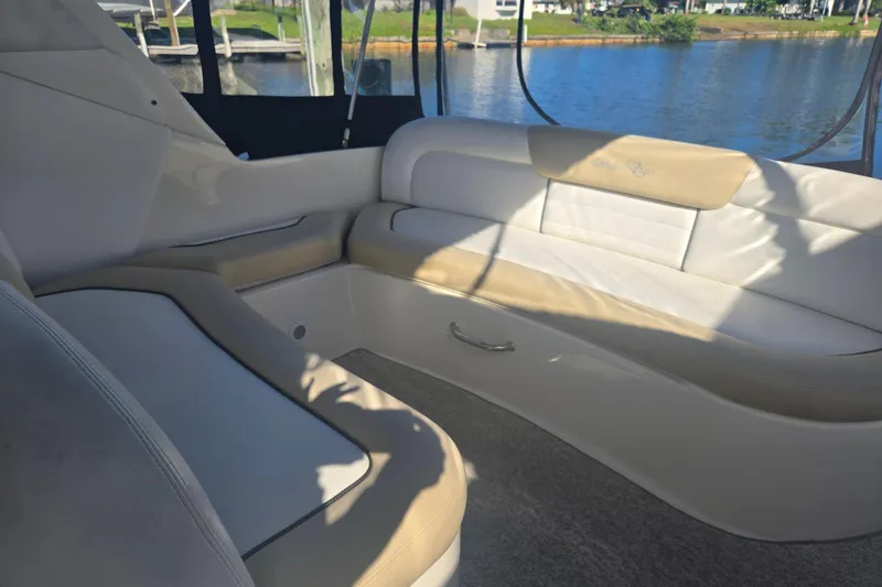 Slide: The Image of Interior seating of 2010 Sea Ray 330 Sundancer boat by the water. - 18