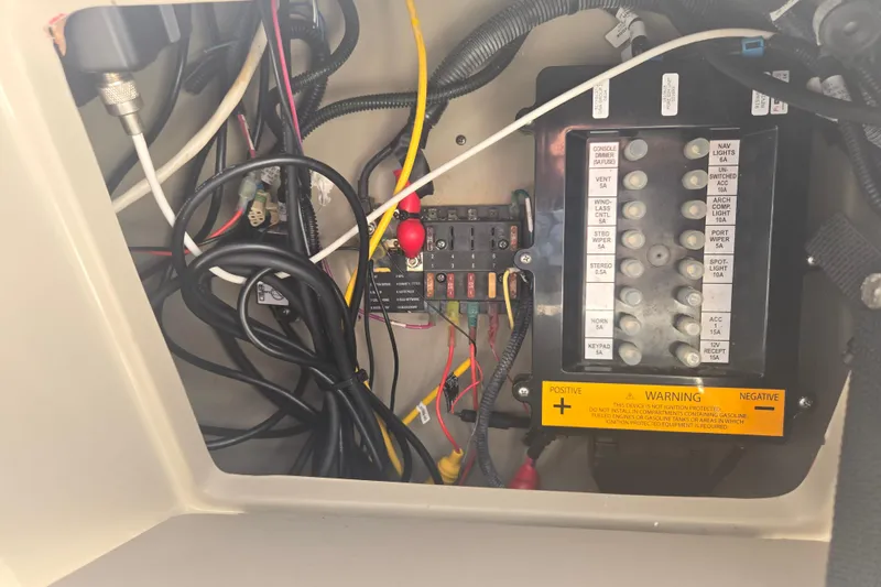 Slide: The Image of Electrical panel of a 2010 Sea Ray 330 Sundancer boat with wiring and fuses. - 21