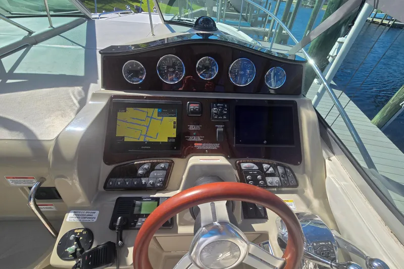 Slide: The Image of 2010 Sea Ray 330 Sundancer helm with navigation system and gauges. - 23