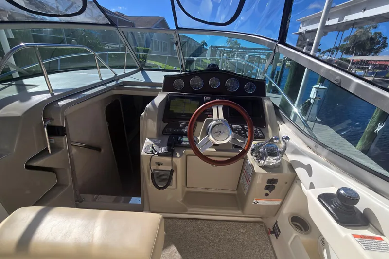 Slide: The Image of Cockpit of 2010 Sea Ray 330 Sundancer with steering wheel and control panel. - 26