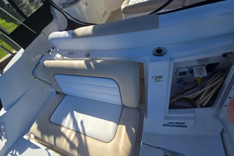 Slide: The Image of 2010 Sea Ray 330 Sundancer boat interior with beige seating and control panel. - 27