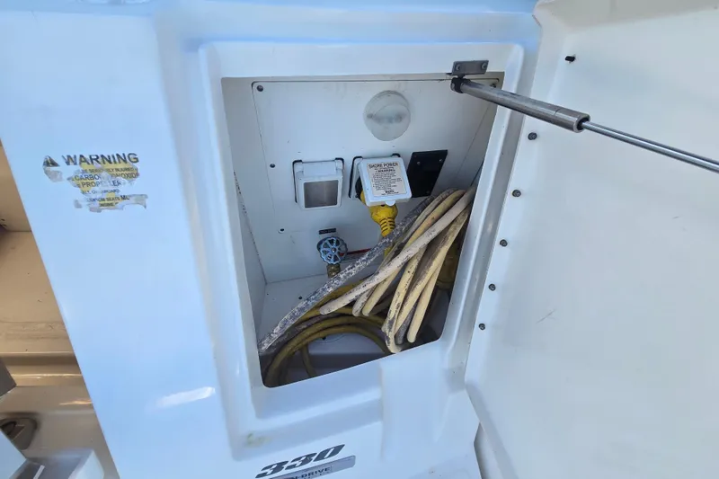 Slide: The Image of Electrical compartment of 2010 Sea Ray 330 Sundancer with shore power connection and cables. - 29