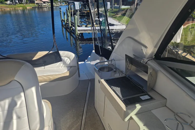 Slide: The Image of Interior of 2010 Sea Ray 330 Sundancer with seating and grill by the water. - 34