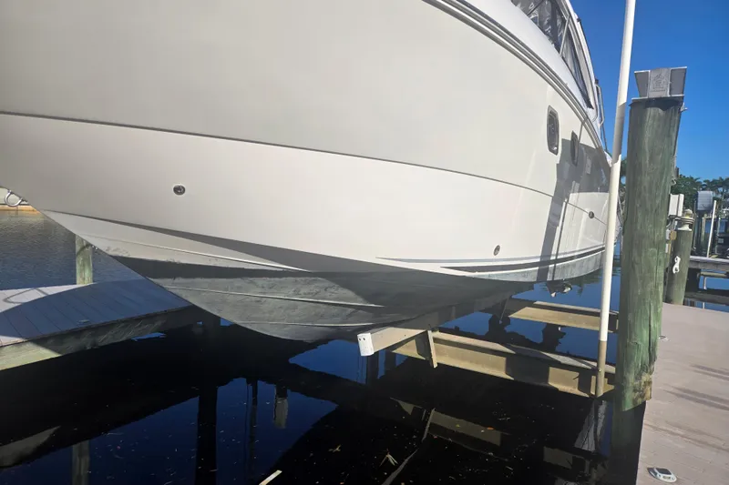 Slide: The Image of 2010 Sea Ray 330 Sundancer yacht on lift at marina dock. - 4