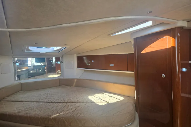 Slide: The Image of Interior cabin of 2010 Sea Ray 330 Sundancer with cozy bed and wooden cabinetry. - 43
