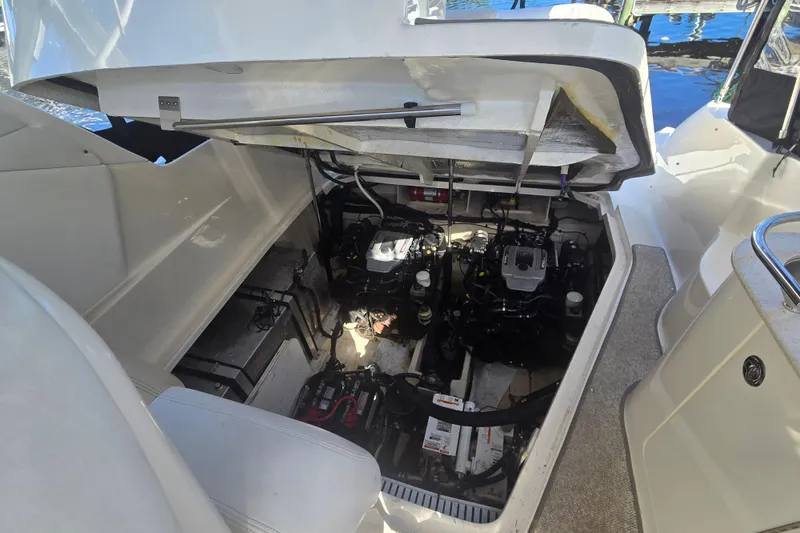 Slide: The Image of Engine compartment of 2010 Sea Ray 330 Sundancer boat, showcasing dual engines and mechanical components. - 52