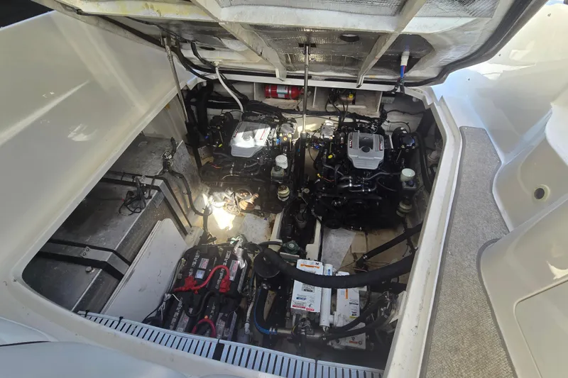 Slide: The Image of Engine compartment of 2010 Sea Ray 330 Sundancer with visible batteries and mechanical components. - 53