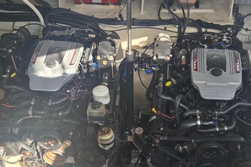 Slide: The Image of Twin engines of a 2010 Sea Ray 330 Sundancer boat, showcasing detailed components. - 54