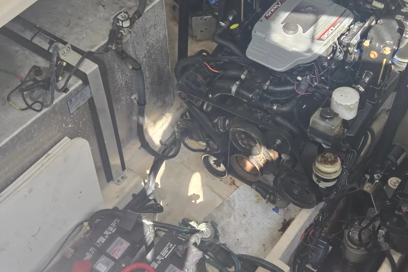 Slide: The Image of Engine compartment of a 2010 Sea Ray 330 Sundancer boat, showcasing mechanical components. - 56