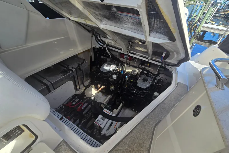 Slide: The Image of Engine compartment of a 2010 Sea Ray 330 Sundancer boat, showing detailed mechanical components. - 58