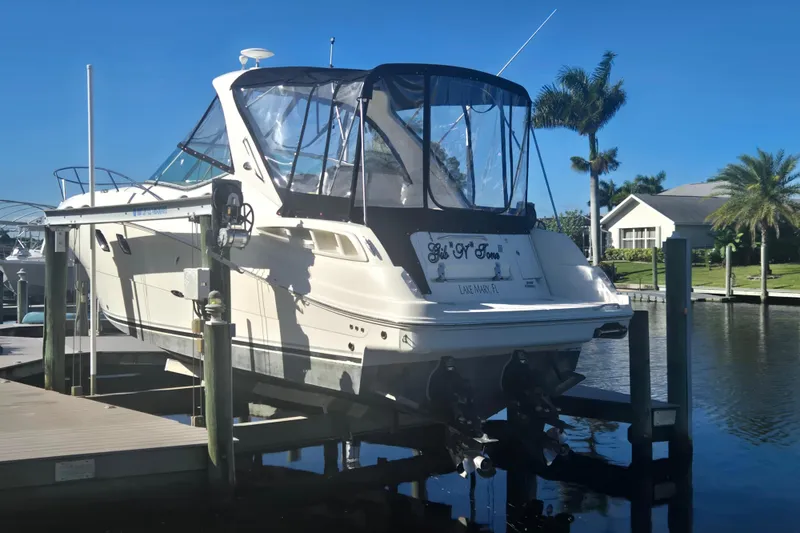 Slide: The Image of 2010 Sea Ray 330 Sundancer docked, featuring sleek design and clear blue sky backdrop. - 8