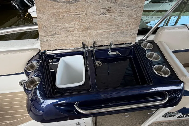 Slide: The Image of 2017 Formula 350 Crossover Bowrider wet bar with sink, cup holders, and storage. - 11