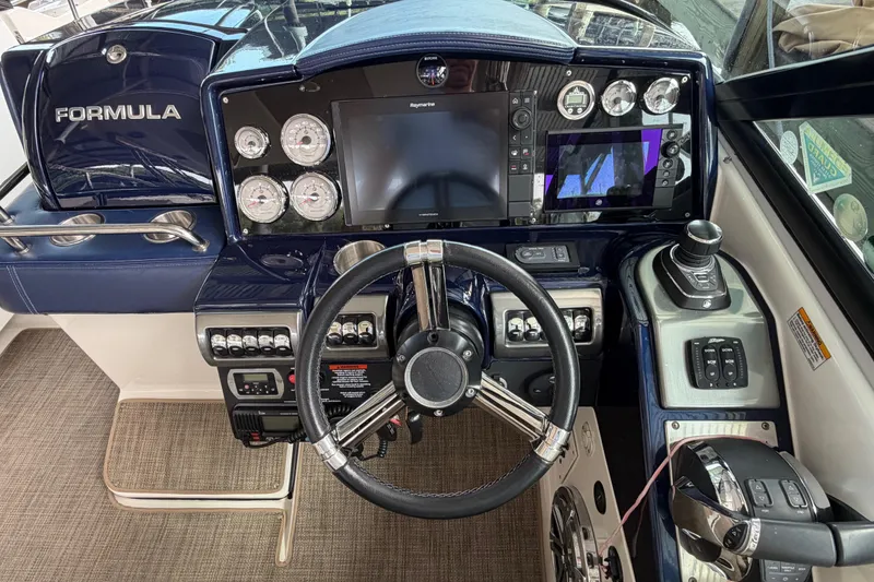 Slide: The Image of 2017 Formula 350 Crossover Bowrider dashboard with steering wheel, gauges, and navigation controls. - 14
