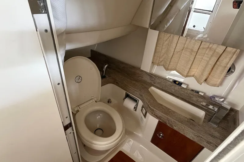 Slide: The Image of 2017 Formula 350 Crossover Bowrider bathroom with toilet, sink, and countertop. - 17