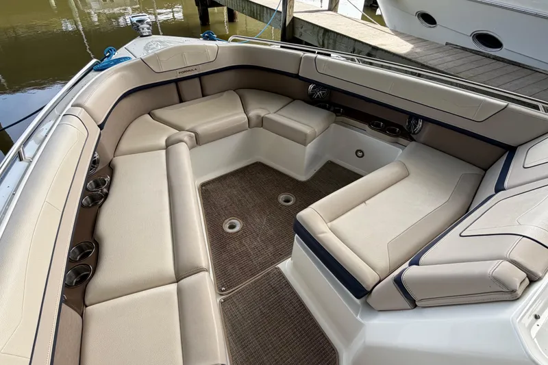 Slide: The Image of 2017 Formula 350 Crossover Bowrider interior with beige seating and cup holders. - 22