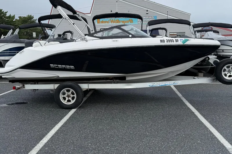 The Image of 2019 Scarab 195G boat on trailer in parking lot, side view. - 1