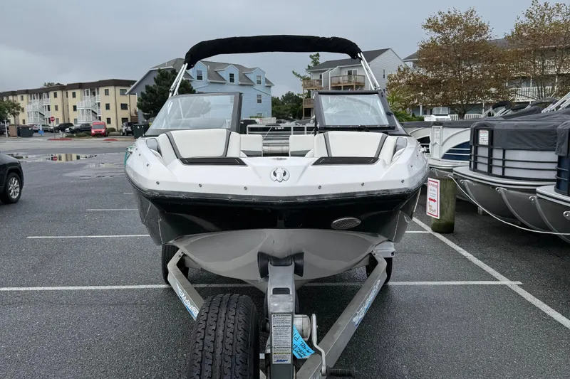 Slide: The Image of Front view of a 2019 Scarab 195G boat on a trailer in a parking lot. - 3