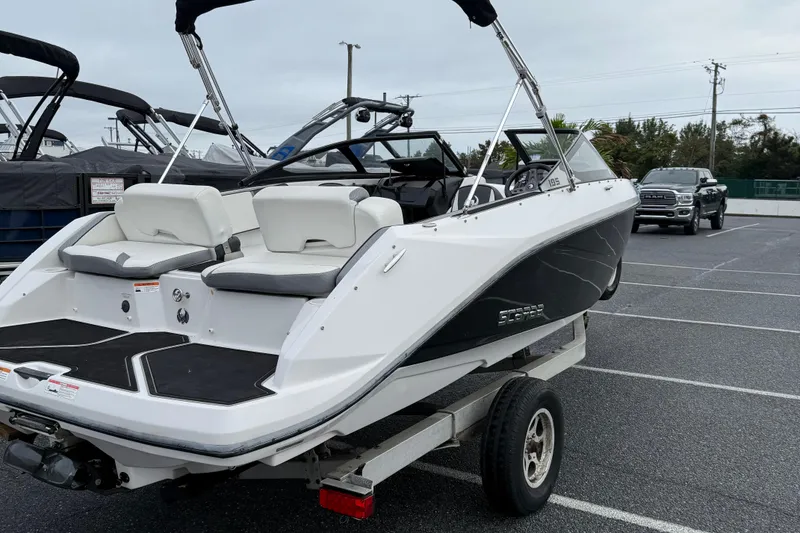 Slide: The Image of 2019 Scarab 195G boat on trailer in parking lot, rear view. - 6