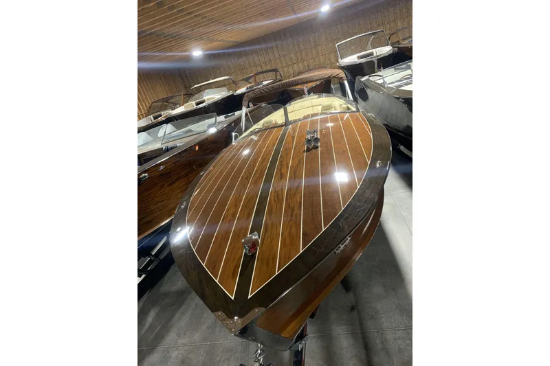 Slide: The Image of 2008 StanCraft 32 Deluxe wooden boat in storage, showcasing elegant craftsmanship. - 1