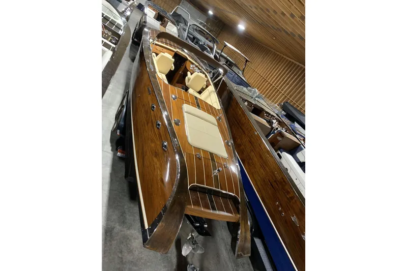 Slide: The Image of 2008 StanCraft 32 Deluxe wooden boat with elegant interior, showcased in a storage facility. - 14