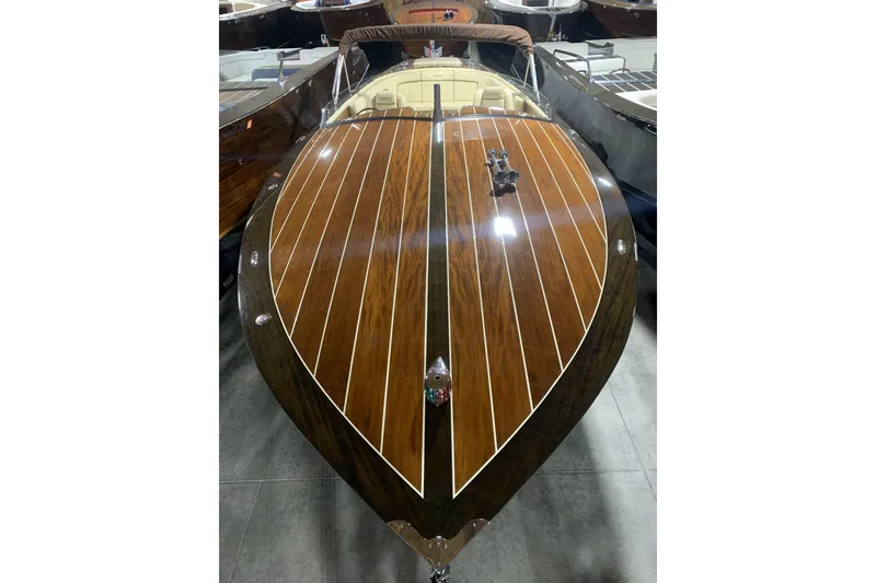 Slide: The Image of 2008 StanCraft 32 Deluxe boat with polished wooden deck in showroom. - 2