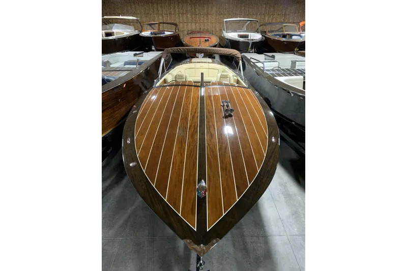Slide: The Image of 2008 StanCraft 32 Deluxe wooden boat in a storage facility, showcasing elegant craftsmanship. - 4