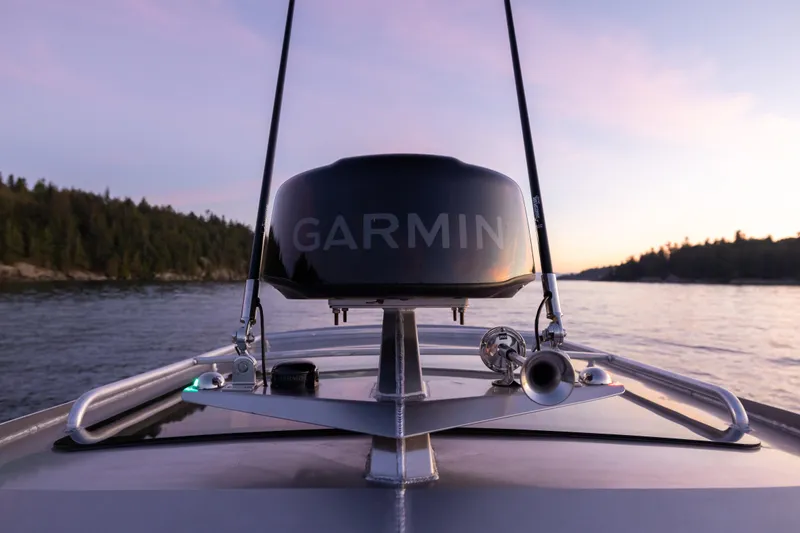 Slide: The Image of 2026 Jasper Marine Defender 22 boat on serene lake with mountainous backdrop. - 16