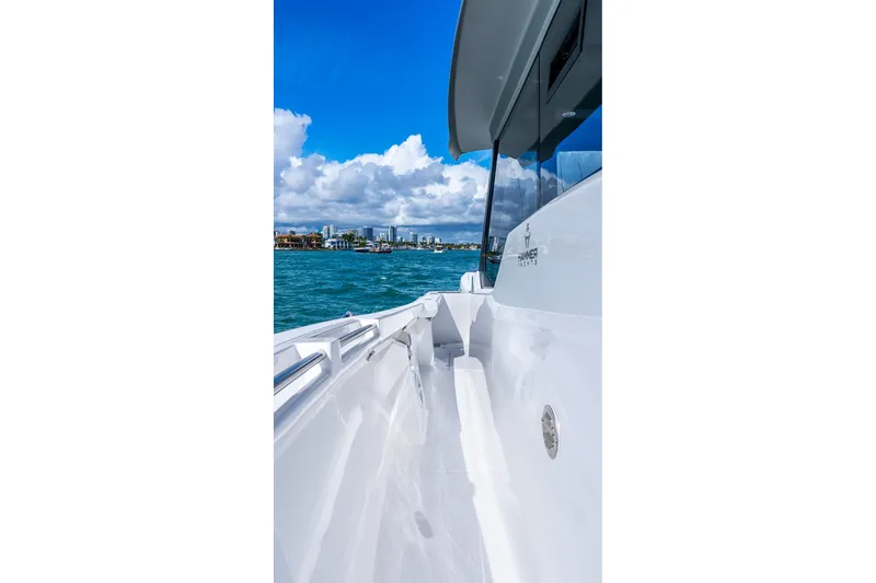 Slide: The Image of 2026 Hammer Yachts 35HH on water, showcasing sleek design and vibrant blue sky. - 14