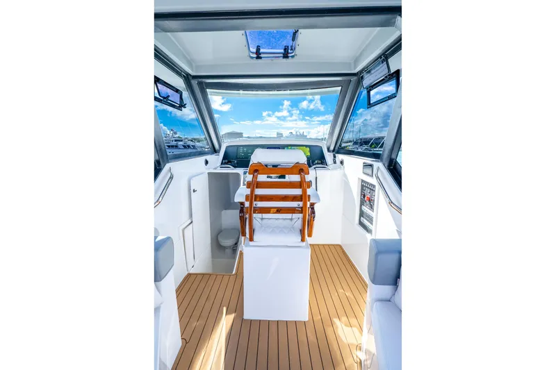 Slide: The Image of Interior of 2026 Hammer Yachts 35HH, featuring modern helm and wooden flooring. - 19
