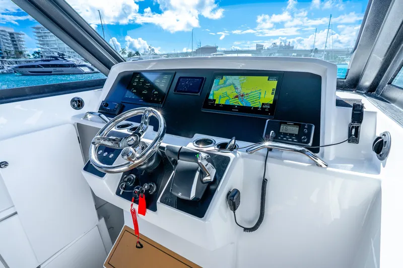 Slide: The Image of Helm of 2026 Hammer Yachts 35HH with navigation screens and steering wheel. - 22