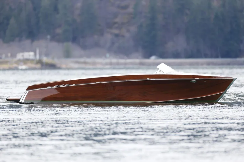 Slide: The Image of 2025 StanCraft 290 Rivelle luxury wooden boat on a serene lake. - 1