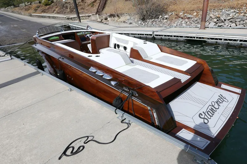 Slide: The Image of 2025 StanCraft 290 Rivelle luxury boat docked, showcasing sleek wooden design and modern features. - 11