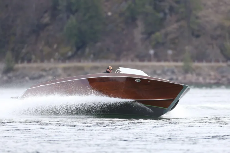 Slide: The Image of 2025 StanCraft 290 Rivelle speedboat cruising on a lake with scenic background. - 5