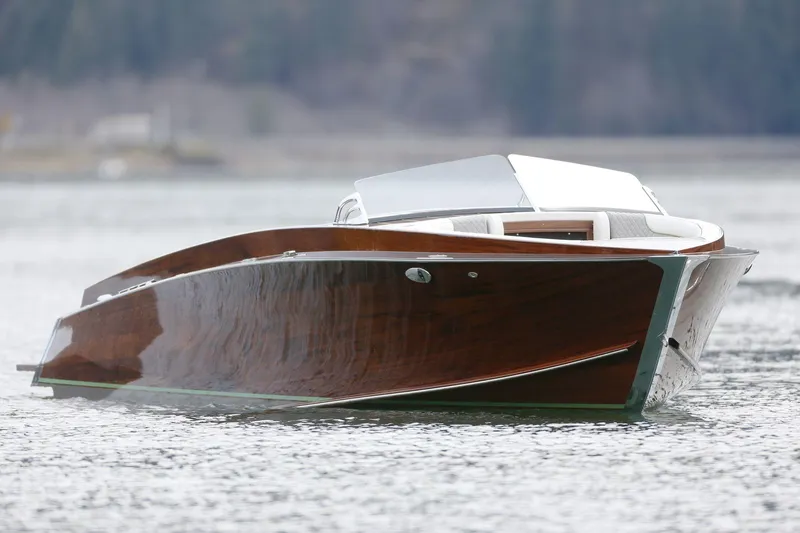 Slide: The Image of 2025 StanCraft 290 Rivelle luxury boat on calm water, showcasing sleek wooden design. - 8