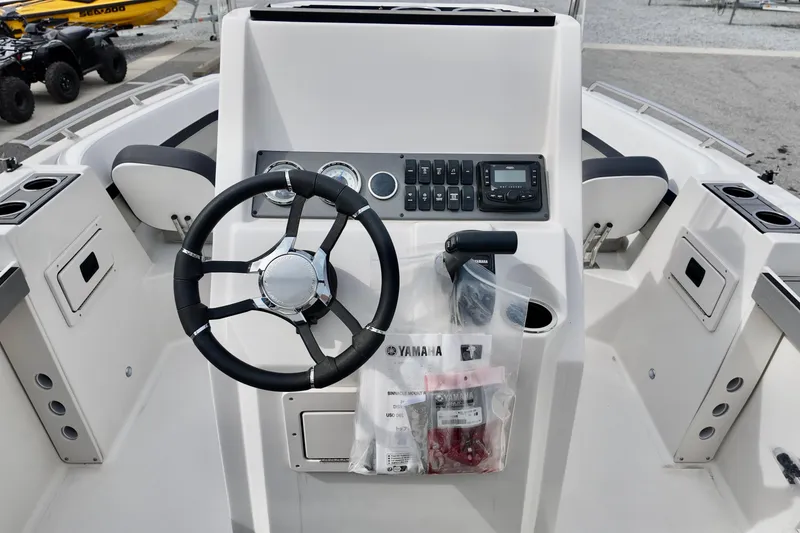 Slide: The Image of 2026 Starcraft SVX 191 OB CC boat console with steering wheel and controls. - 11