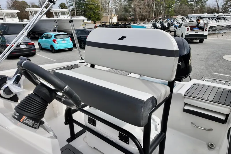 Slide: The Image of 2026 Starcraft SVX 191 OB CC boat interior with steering wheel and seating. - 12