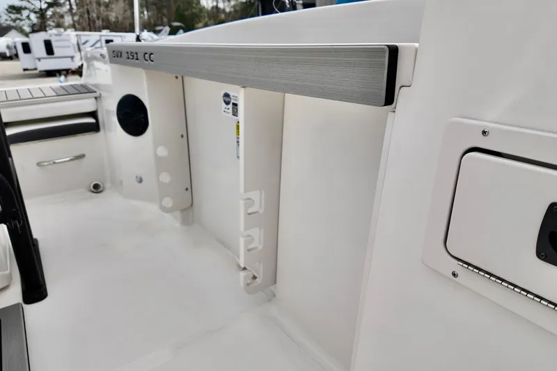 Slide: The Image of 2026 Starcraft SVX 191 OB CC boat interior, featuring sleek white design and storage compartments. - 13