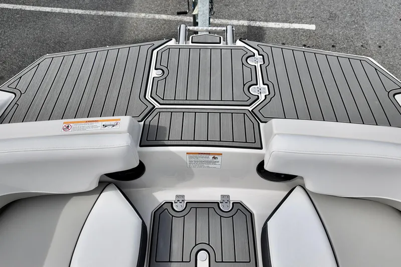 Slide: The Image of 2026 Starcraft SVX 191 OB CC boat deck with sleek gray flooring and white seating. - 16