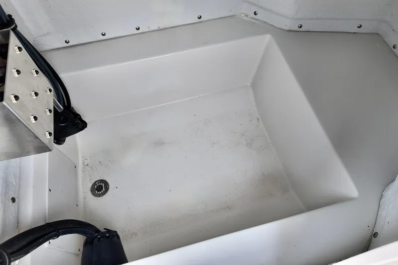 Slide: The Image of Interior view of 2026 Starcraft SVX 191 OB CC boat compartment, featuring drainage and wiring. - 7