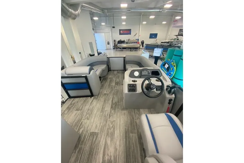 Slide: The Image of 2026 Bentley Pontoons Bolt interior with modern seating and steering console in showroom. - 5