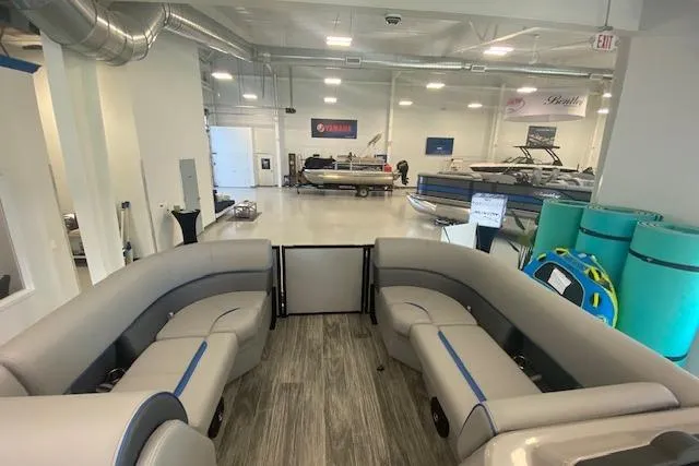 Slide: The Image of 2026 Bentley Pontoons Bolt interior in showroom, featuring spacious seating and modern design. - 7