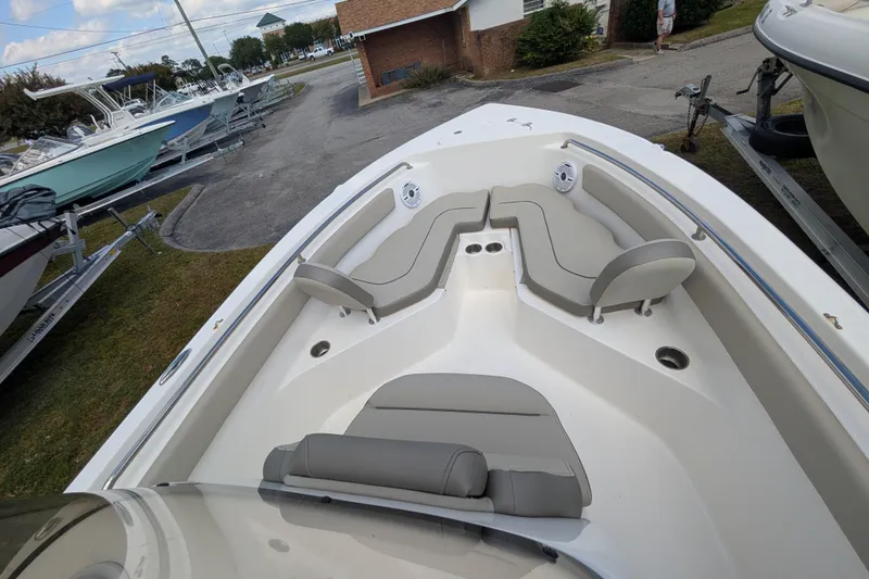 Slide: The Image of 2023 Key West 203 FS boat interior with cushioned seating and cup holders. - 12