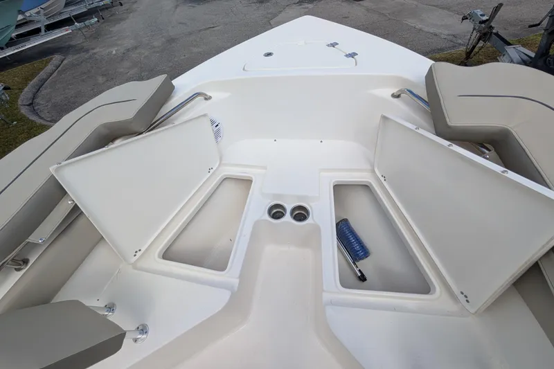 Slide: The Image of 2023 Key West 203 FS boat interior with open storage compartments and seating. - 14