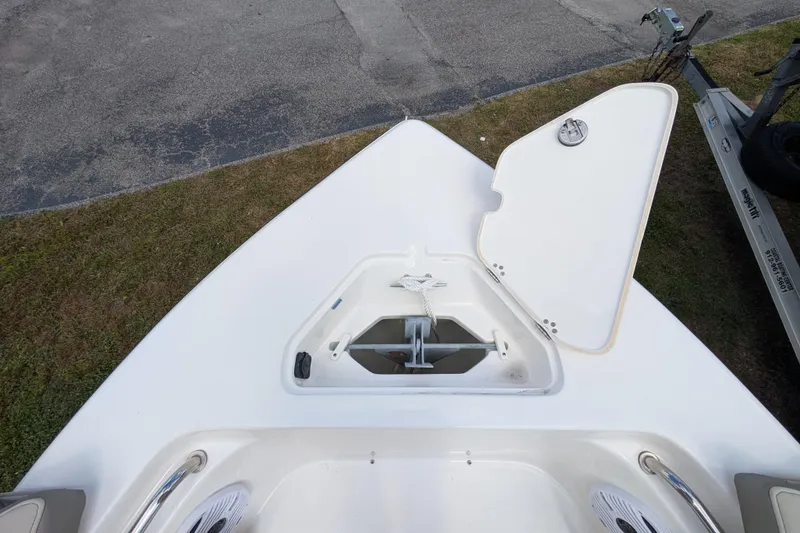 Slide: The Image of 2023 Key West 203 FS boat anchor compartment with open hatch, showcasing storage space. - 15