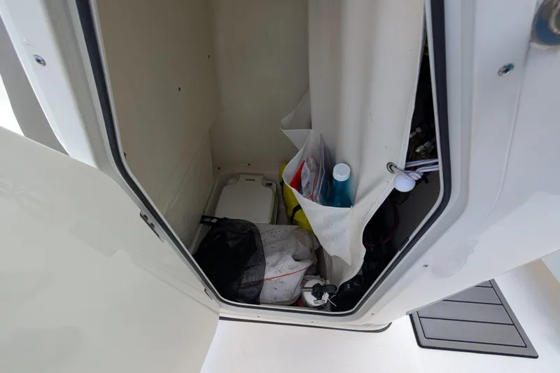 Slide: The Image of Storage compartment in 2023 Key West 203 FS boat, featuring organized supplies and equipment. - 16